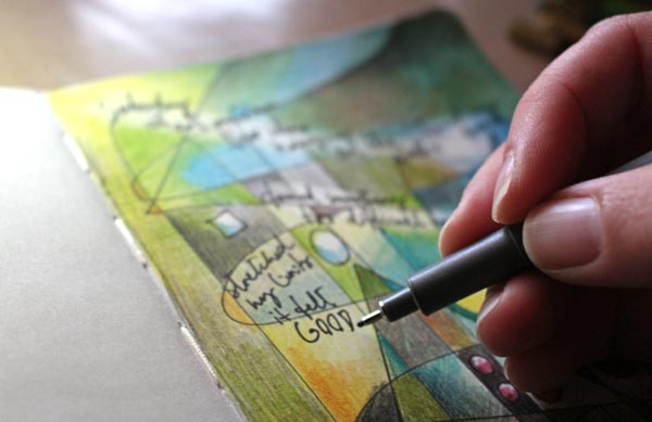 Journaling on a colored art journal page, by Peony and Parakeet