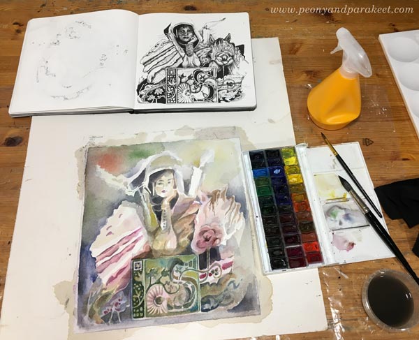Creating a watercolor painting from an ink drawing. Using a sketchbook as an inspiration for watercolors. Watercolor painting in progress. By Paivi Eerola from Peony and Parakeet.