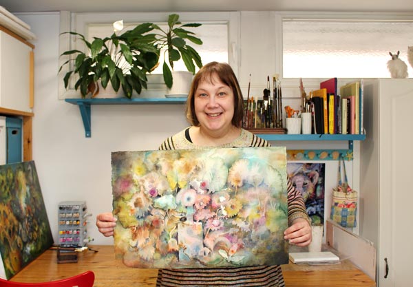 Paivi Eerola in her studio showing her watercolor painting Abracadabra.