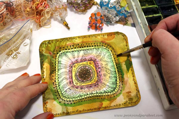 Decorating a tin box with beads, embroidery floss, and hand-drawn and hand-painted papers. Inspired by Sanditon tv series. By Paivi Eerola of Peony and Parakeet.