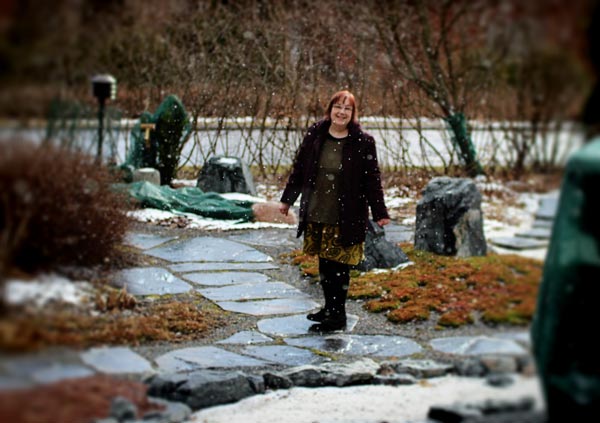 Paivi Eerola in the garden. Snowing in Finland.