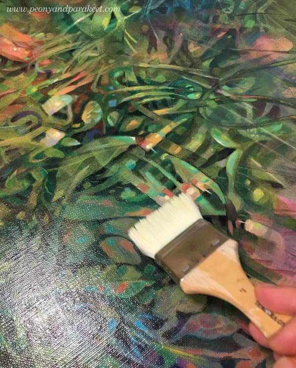 Varnishing an acrylic painting. By artist Paivi Eerola of Peony and Parakeet.