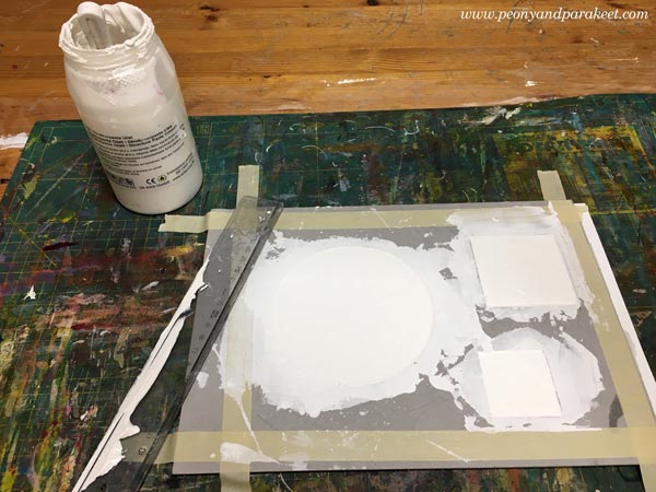 Filling cardboard templates with structure paste. Making reliefs for an acrylic painting.