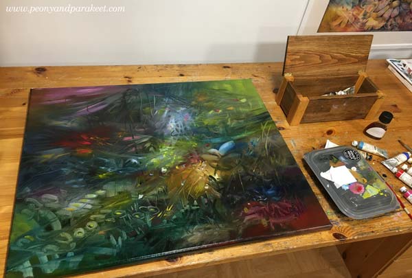 Oil painting in progress. Adding finishing touches by laying the painting on the table. By Paivi Eerola of Peony and Parakeet.