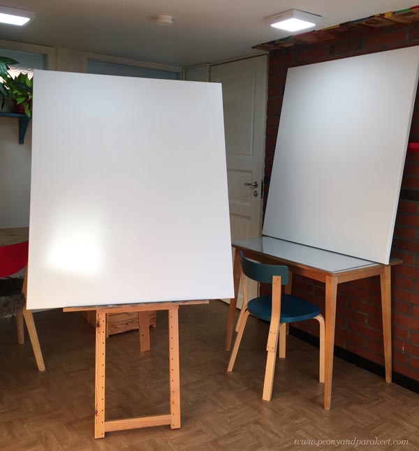 Huge canvases in a little artist studio.