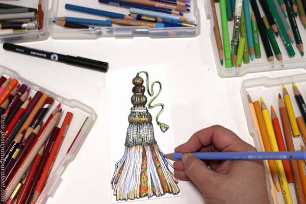 Coloring a tassel with colored pencils.