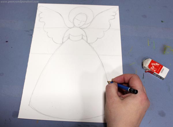 Sketching a winter angel with a pencil.