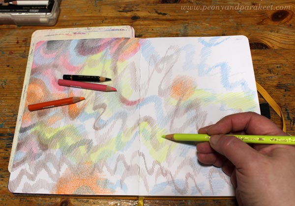 Coloring freely with colored pencils.