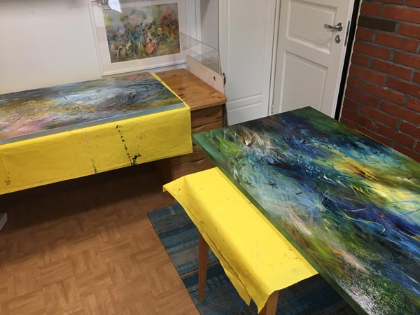 Paintings that are freshly varnished. Being an artist requires performing all kinds of tasks.