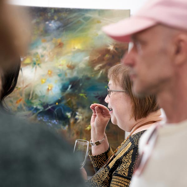 At the opening of an art exhibition. The artist Paivi Eerola talks about her work. Photo by Tiina Apilo.