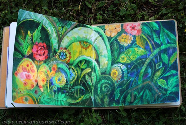 A maximalist style spread in the Dylusions Creative Journal square. Green plants and colorful ornaments.