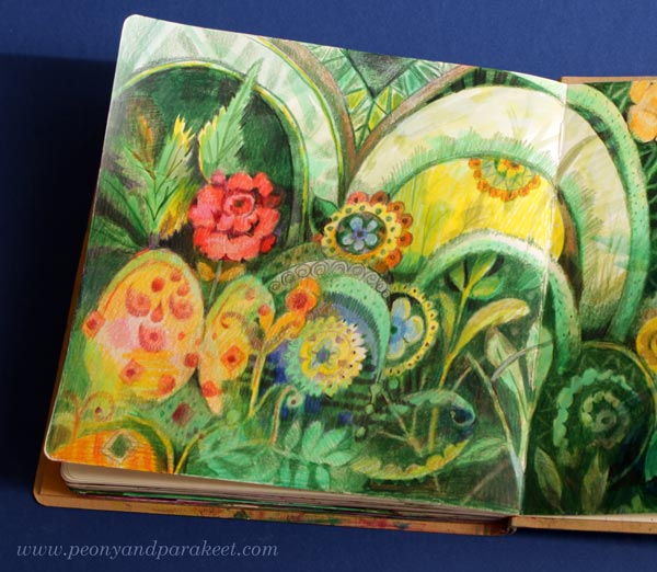 A close-up of a maximalist style art journal spread with plants and ornaments.