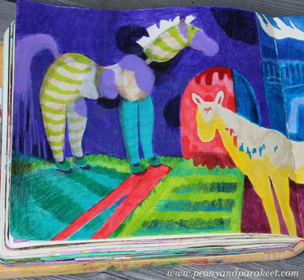 A close-up of a colorful art journal spread with horses.