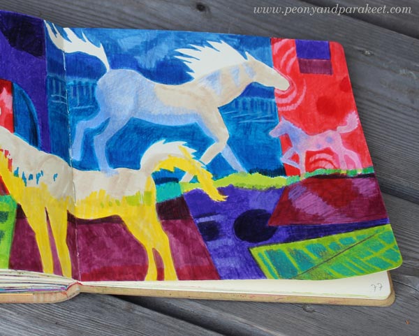 A close-up of a colorful art journal spread with horses.