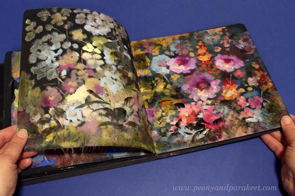 Black art journal filled with leftover paints