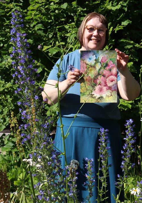 Artist Päivi Eerola from Finland holding one of her watercolor paintings.