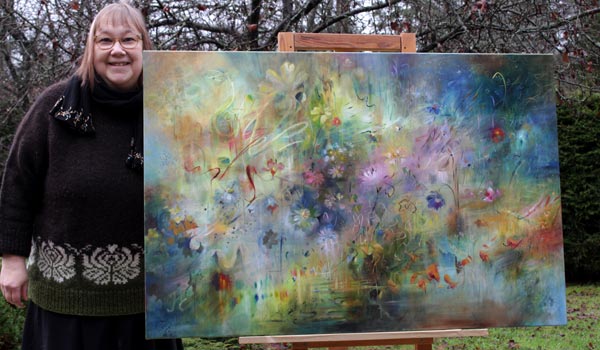 Paivi Eerola and her oil painting Cosmos.