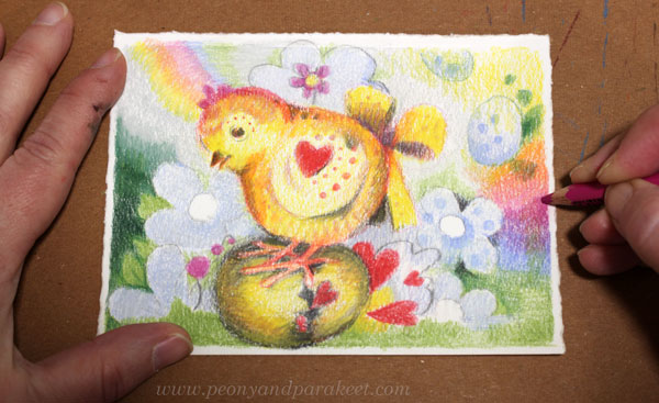 Drawing a happy and colorful background with colored pencils.