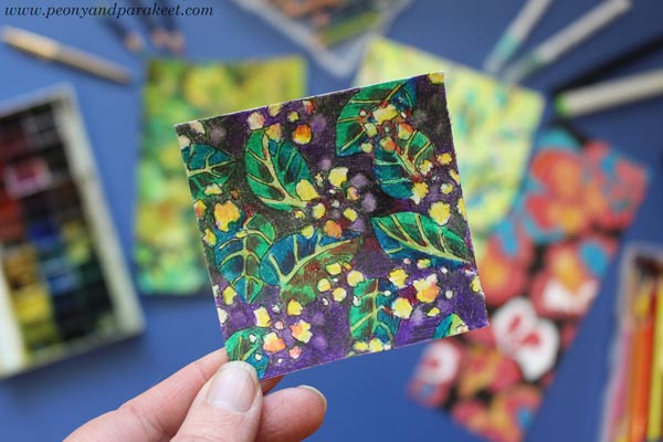A tiny scrap of paper with a hand-drawn surface design.