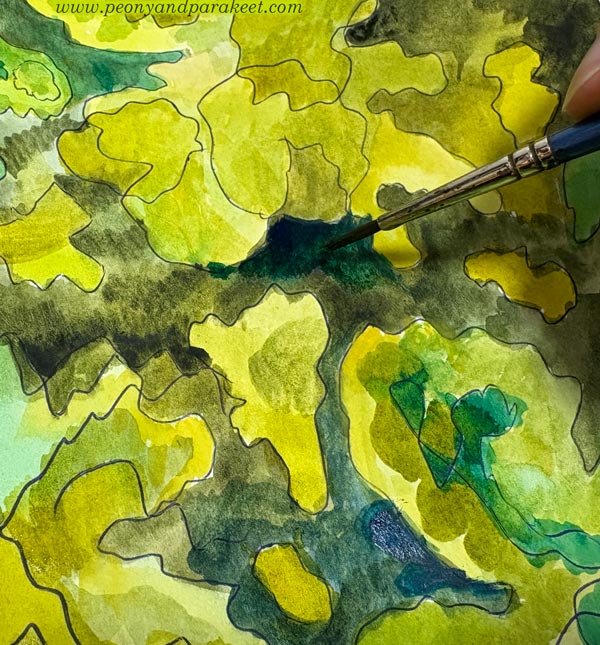Painting a free-form drawing with watercolors.
