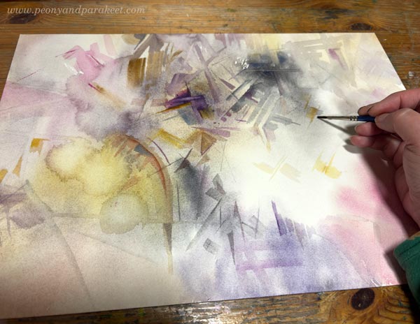 Painting small geometric shapes to create an abstract composition