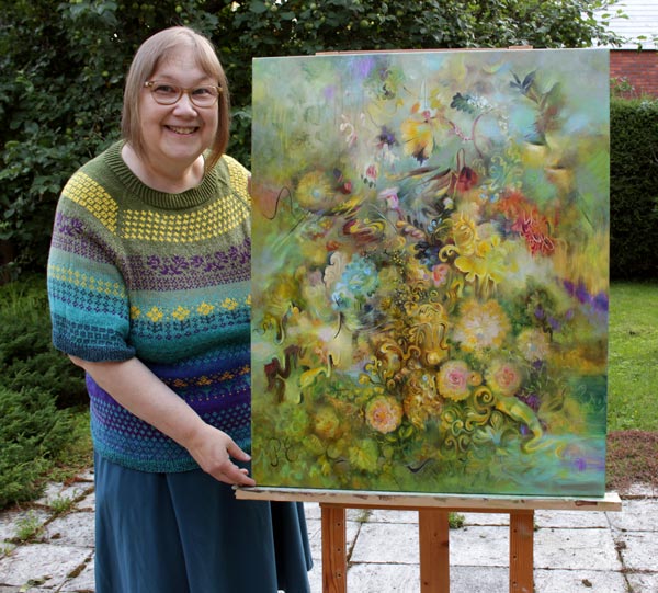 Päivi Eerola and her painting titled Golden.