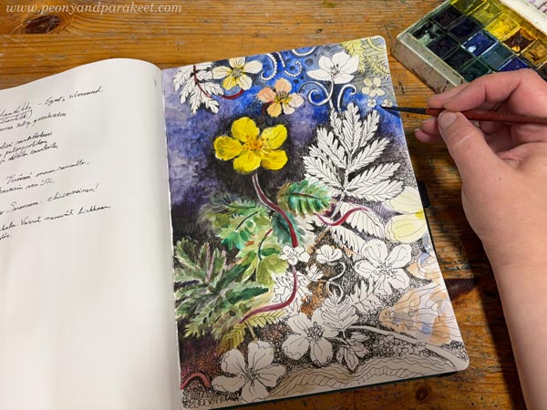 Using watercolors on a sketchbook.