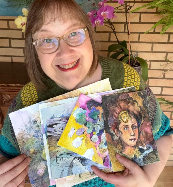 Finnish artist Päivi Eerola holding the drawings for the course Drawing Soulfully